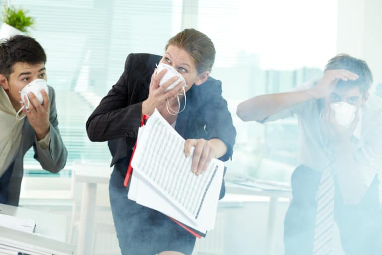 Three,Business,People,In,Gas,Masks,Gasping,In,Office